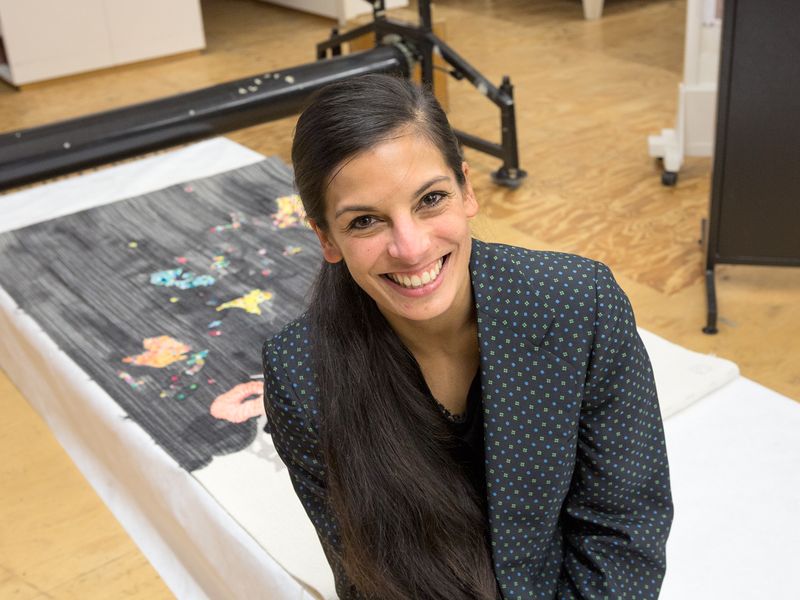 Artist Sangeeta Sandrasegar with the work she designed, Everything has two witnesses, one on earth and one in the sky (2014)