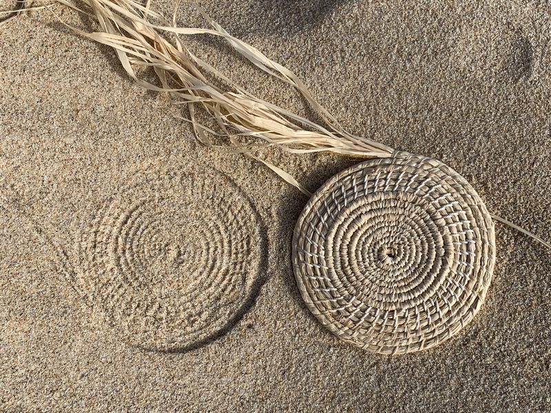 Melinda Young, Thinking/making - an impression in the sand, Woven component, Raffia and found string. 31 March 2020